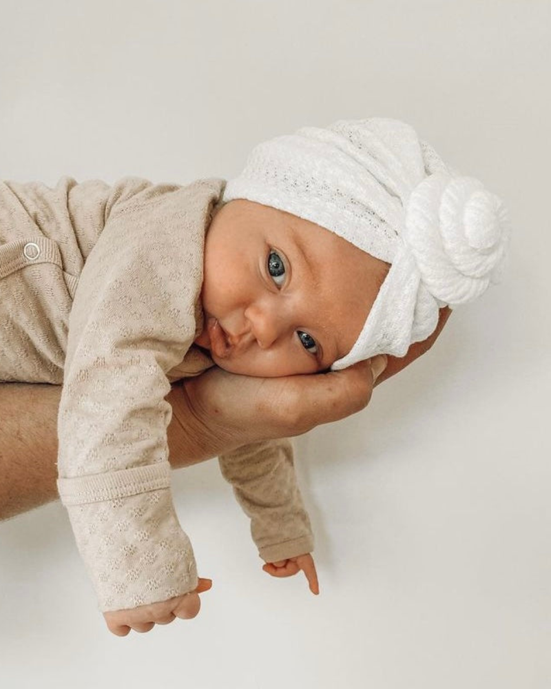 Baby in Mae and Rae White Turban looking adorable