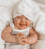 Cheeky baby wearing a white waffle knot turban