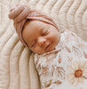 Sleeping baby wearing a dusty pink waffle knot turban