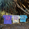 Cosmic Tees in Grape, Butter and Aqua hanging on a clothesline, showing the back prints