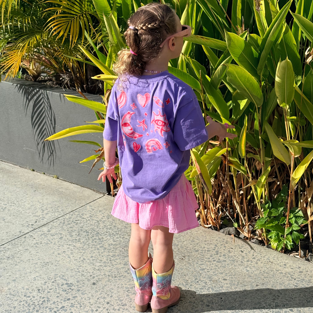 Girl standing outside in the Grape Cosmic Tee