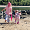 Two kids walking on the beach in Baby Pink Dreamers Tees, one in blue and one in pink Stardust Flares
