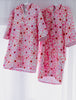 Mae and Rae Zahli hooded beach towel with floral pattern, hung in studio lighting