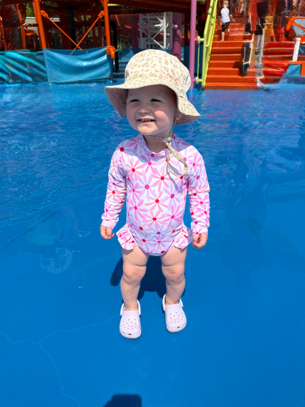 Baby girl in her Mae and Rae Zahli swimmers with frill detail on the Gold Coast 